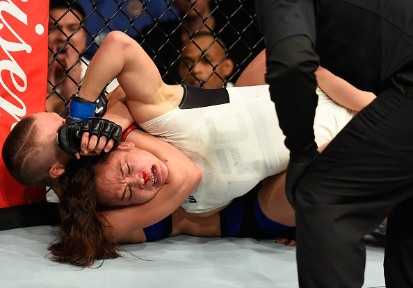 R. Namajunas locks in a rear naked choke on M. Waterson (in white) (Photo: Josh Hedges/UFC)